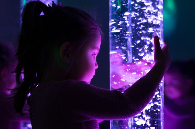Toddler holding sensory bubble lamp